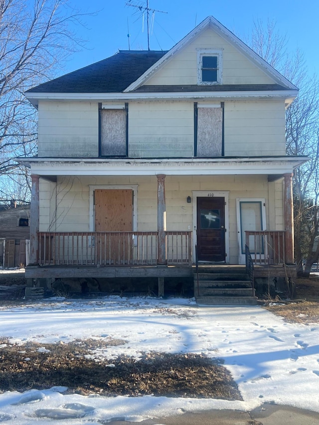 view of front of home with covered porch and roof with shingles