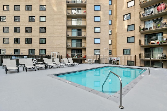 view of swimming pool with fence