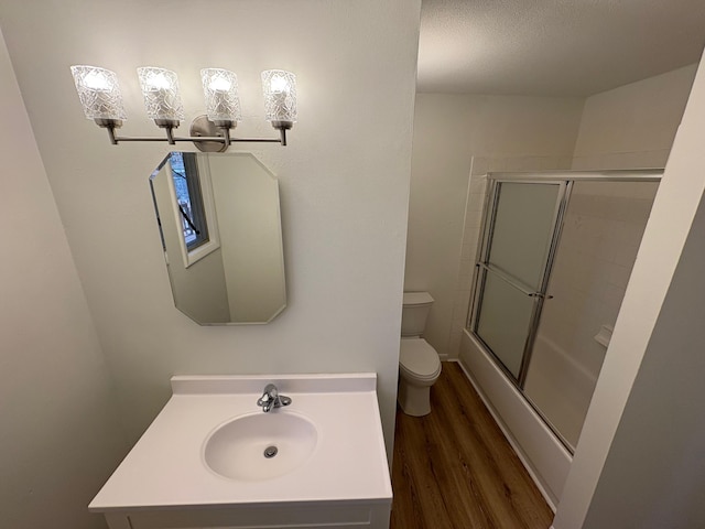 bathroom featuring vanity, toilet, and wood finished floors