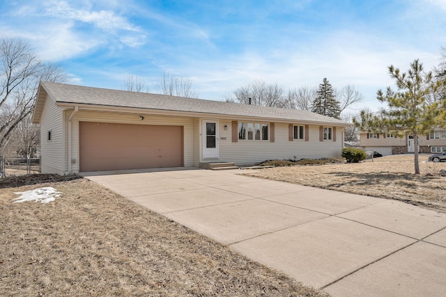 single story home with an attached garage, a shingled roof, and driveway