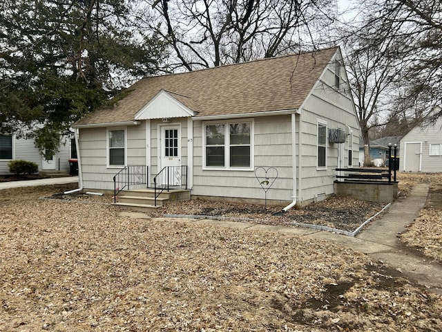 bungalow-style home featuring a shingled roof