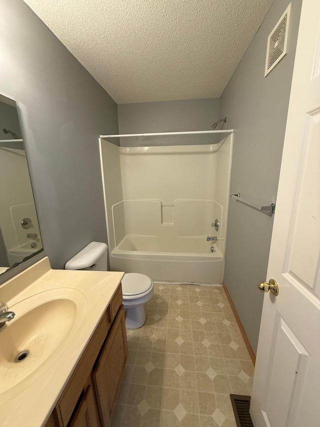 full bathroom featuring bathing tub / shower combination, toilet, visible vents, and a textured ceiling