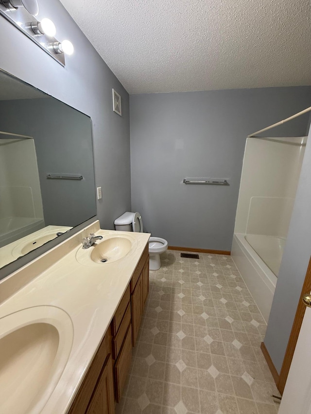 full bath with a sink, visible vents, and a textured ceiling