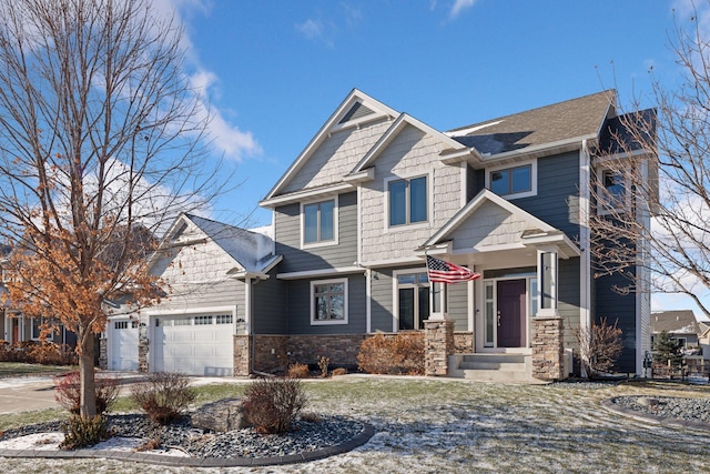 craftsman-style house featuring a garage, stone siding, and concrete driveway