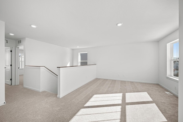 unfurnished room featuring recessed lighting, visible vents, baseboards, and light colored carpet