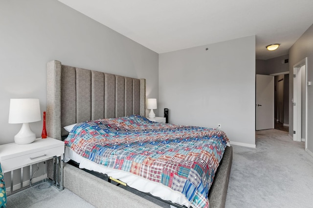 carpeted bedroom featuring baseboards