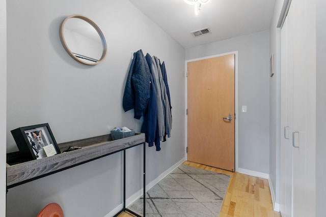 entrance foyer featuring light wood-type flooring, baseboards, and visible vents