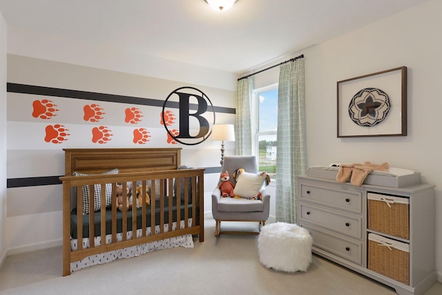 bedroom with a nursery area and carpet floors