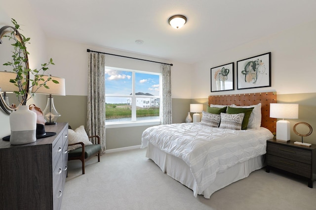 bedroom with baseboards and light carpet