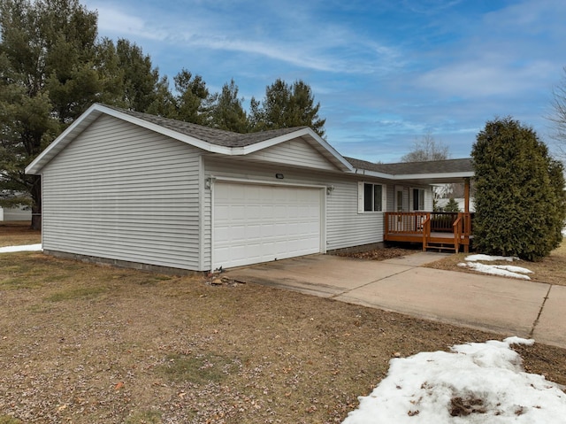 view of property exterior with a garage and concrete driveway