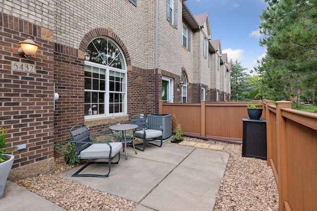 view of patio / terrace with central AC and fence