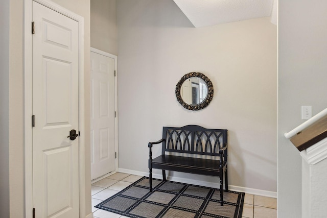 living area with light tile patterned floors and baseboards