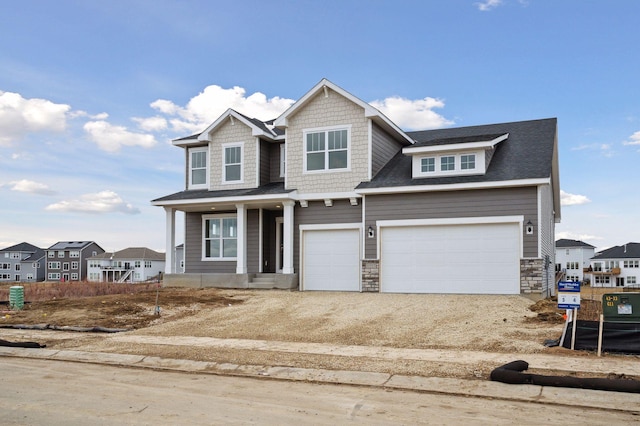 craftsman-style house with dirt driveway and stone siding