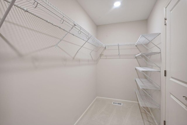 spacious closet featuring visible vents and carpet flooring