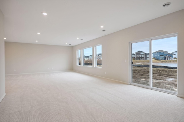 unfurnished room featuring baseboards, recessed lighting, visible vents, and light colored carpet