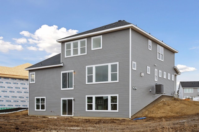 rear view of property featuring central air condition unit