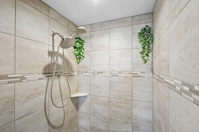 interior details with a tile shower