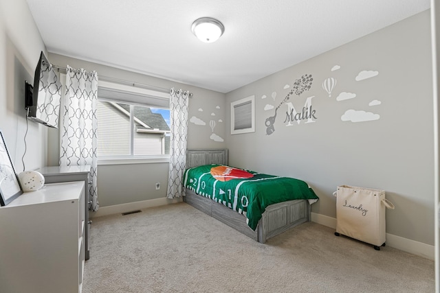 carpeted bedroom featuring visible vents and baseboards