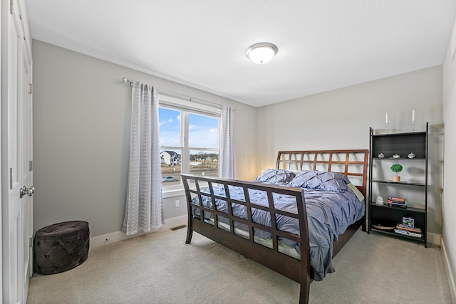 bedroom featuring carpet floors, visible vents, and baseboards