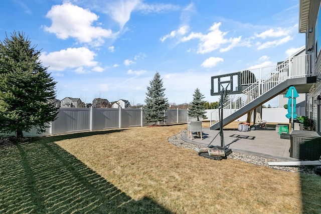 view of yard featuring a fenced backyard, stairway, and a patio