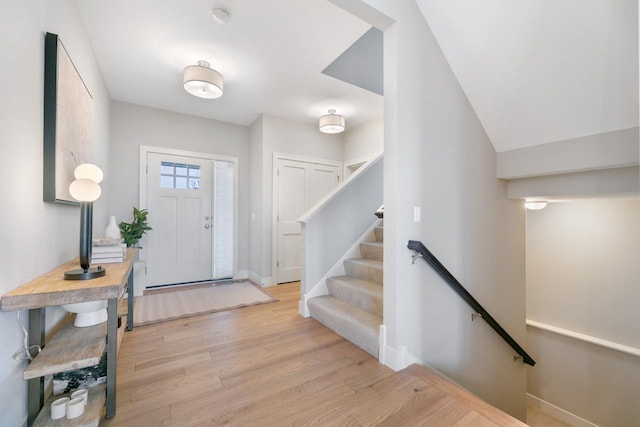 foyer featuring baseboards and light wood-type flooring