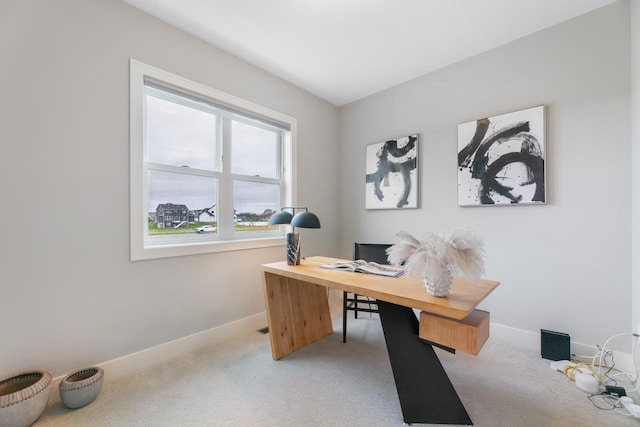 office with baseboards and light carpet