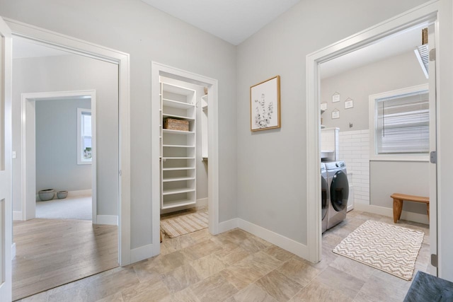 laundry room featuring independent washer and dryer, laundry area, and baseboards
