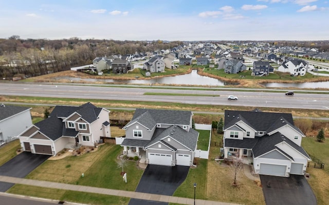 drone / aerial view featuring a water view and a residential view
