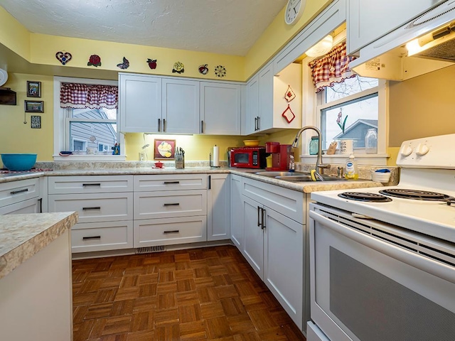 kitchen with white electric stove, light countertops, a sink, a textured ceiling, and extractor fan