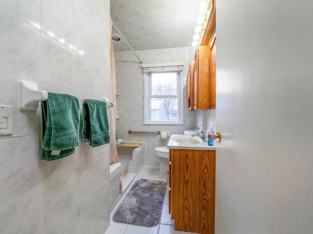 bathroom featuring bathing tub / shower combination, toilet, tile patterned flooring, vanity, and tile walls