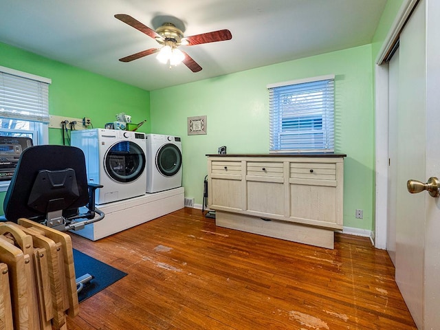 laundry room with separate washer and dryer, wood finished floors, cabinet space, and a healthy amount of sunlight