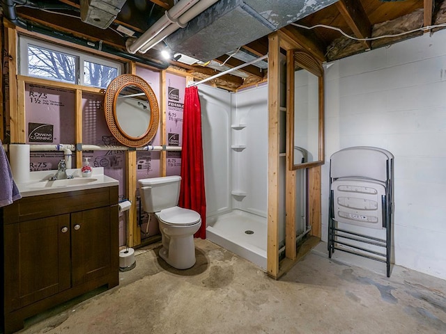 bathroom with a stall shower, vanity, toilet, and unfinished concrete floors