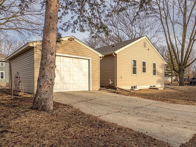 view of property exterior with a garage and concrete driveway