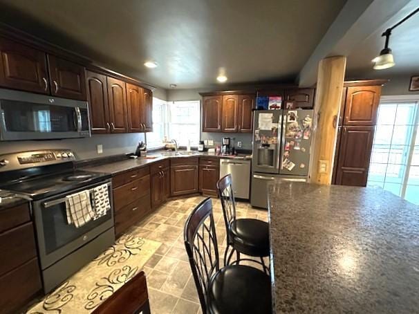 1344 385th Ave, Ten Mile Lake Twp, MN 56218 - kitchen featuring stainless steel appliances, a sink, dark countertops, recessed lighting, and dark brown cabinets
