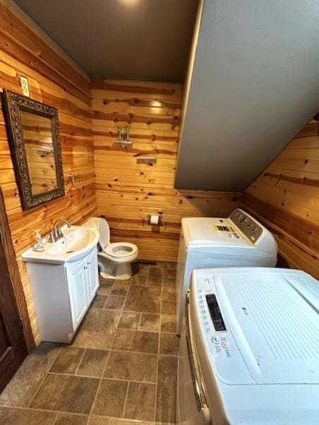 1344 385th Ave, Ten Mile Lake Twp, MN 56218 - laundry room featuring wood walls and separate washer and dryer