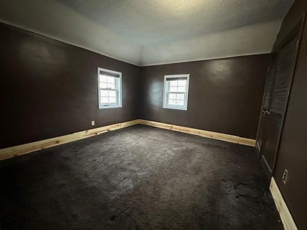 1344 385th Ave, Ten Mile Lake Twp, MN 56218 - empty room featuring baseboards, carpet, and a textured ceiling