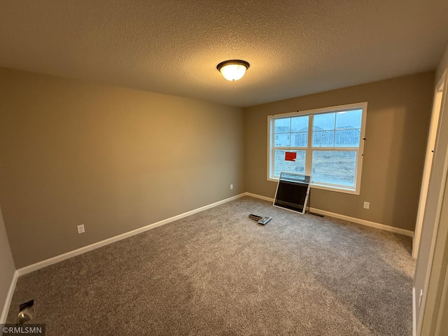 unfurnished bedroom featuring carpet floors, baseboards, and a textured ceiling