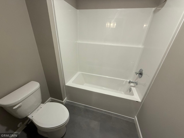 bathroom featuring bathtub / shower combination and toilet