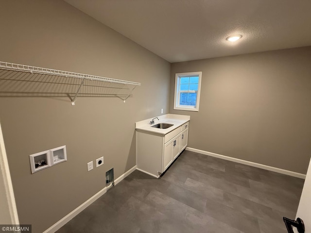 washroom with washer hookup, cabinet space, hookup for an electric dryer, a sink, and baseboards