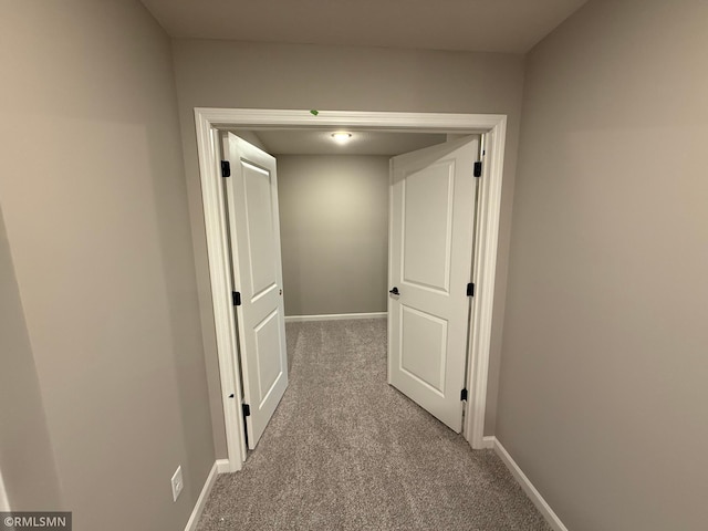 hall with baseboards and carpet flooring