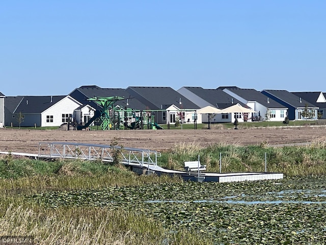 view of yard featuring a residential view and playground community