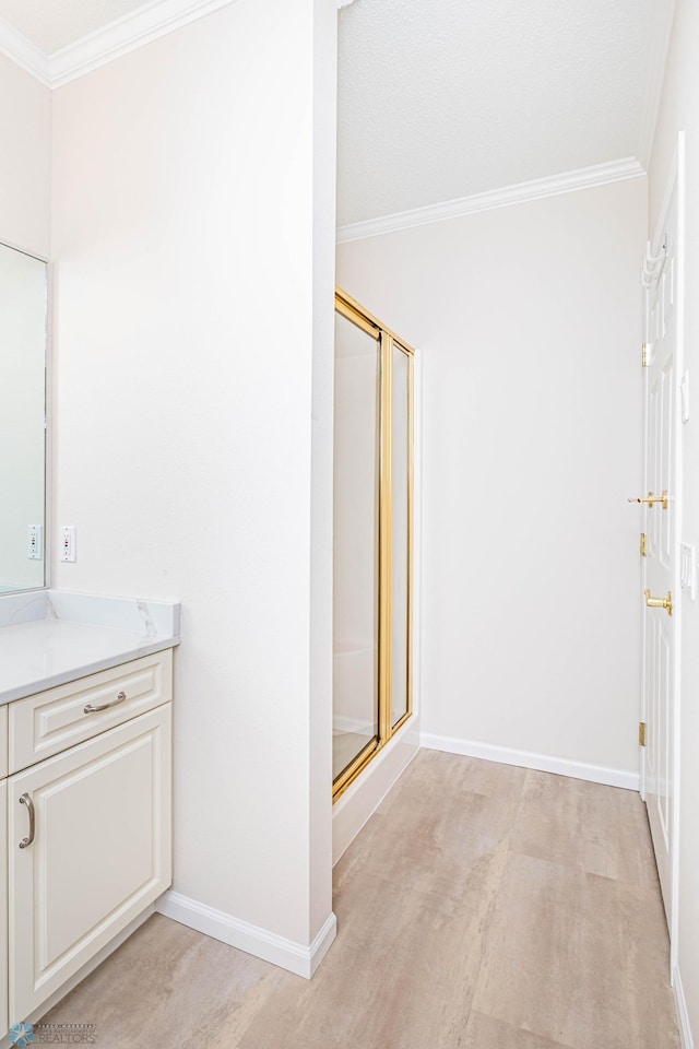 2501 30th Ave S Unit 102, Fargo, ND 58103 - full bath with ornamental molding, vanity, a stall shower, and baseboards