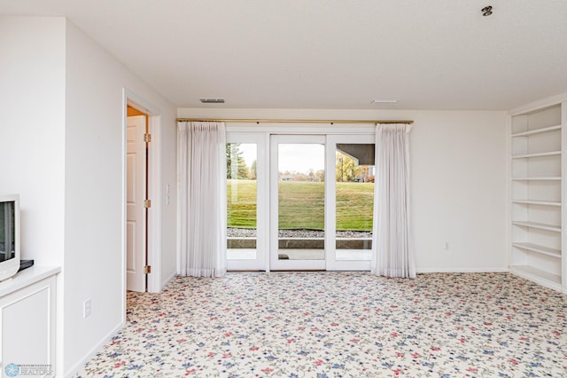 2501 30th Ave S Unit 102, Fargo, ND 58103 - empty room with built in shelves and baseboards