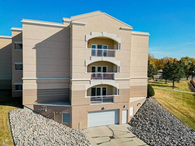 2501 30th Ave S Unit 102, Fargo, ND 58103 - view of building exterior featuring a garage and concrete driveway