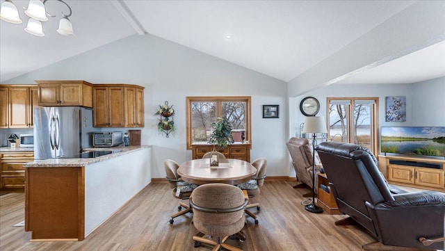 kitchen featuring open floor plan, stainless steel appliances, and wood finished floors