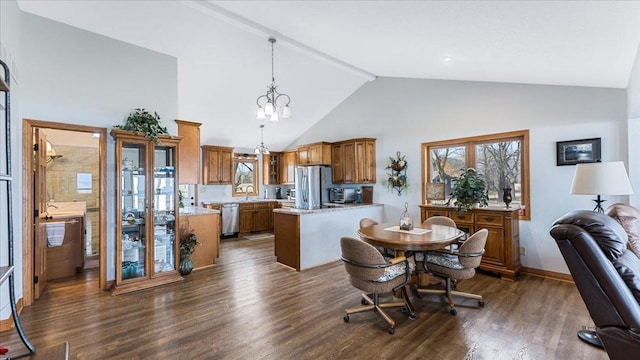 dining space featuring baseboards, dark wood-type flooring, a chandelier, and high vaulted ceiling