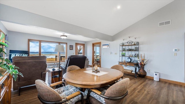 dining space with lofted ceiling, wood finished floors, visible vents, and baseboards