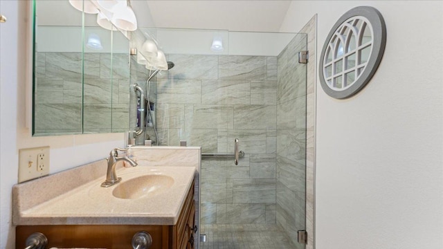 full bath with a stall shower and vanity