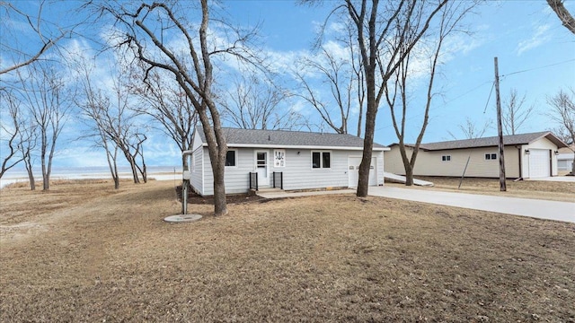 ranch-style house featuring a garage and concrete driveway