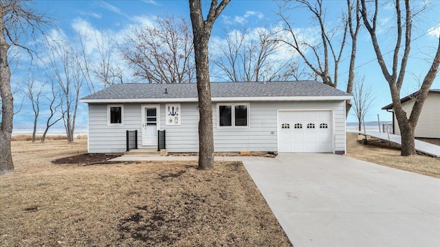 single story home with driveway, a front yard, a garage, and roof with shingles